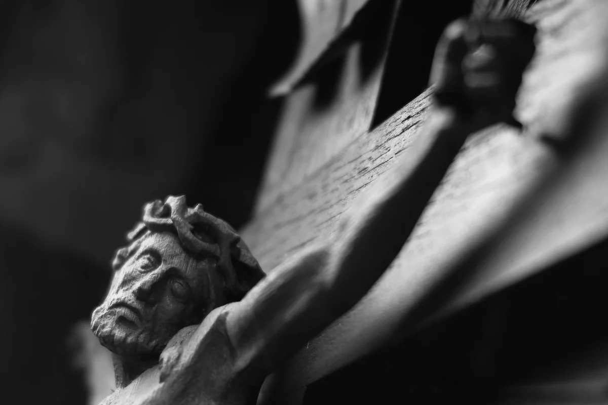 A black and white photograph of a carved crucifix.